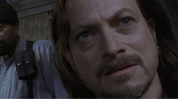 Movie still from “Reindeer Games” (2000), directed by John Frankenheimer – A person with long hair and a beard; Close Up shot, Over the shoulder angle