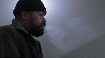 Movie still from “Reindeer Games” (2000), directed by John Frankenheimer – A man with a beard is smoking a cigarette; Close Up shot, Low angle