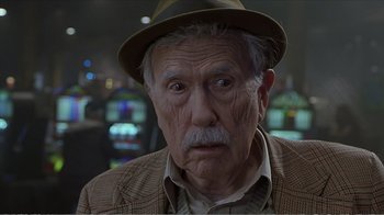 Movie still from “Reindeer Games” (2000), directed by John Frankenheimer – An old man with a hat and a mustache; Close Up shot, Low angle