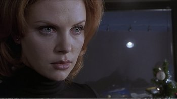 Movie still from “Reindeer Games” (2000), directed by John Frankenheimer – A woman's face in front of a night sky; Close Up shot, Low angle