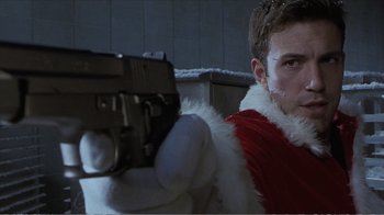 Movie still from “Reindeer Games” (2000), directed by John Frankenheimer – A man in a red jacket holding a gun; Close Up shot, Low angle