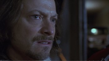 Movie still from “Reindeer Games” (2000), directed by John Frankenheimer – A man's face in a dark room; Close Up shot, Over the shoulder angle