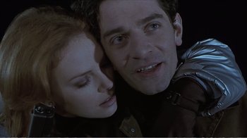 Movie still from “Reindeer Games” (2000), directed by John Frankenheimer – A man and a woman embracing each other in the dark; Close Up shot, Low angle