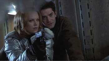 Movie still from “Reindeer Games” (2000), directed by John Frankenheimer – A man and a woman are holding a gun; Close Up shot, Low angle