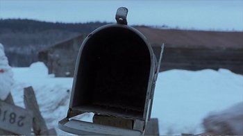Movie still from “Reindeer Games” (2000), directed by John Frankenheimer – An open mail box in the middle of a snow covered field; Close Up shot, Low angle