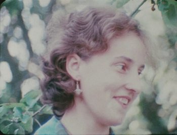 Movie still from “Reminiscences of a Journey to Lithuania” (1972), directed by Jonas Mekas – A person wearing a green shirt; Close Up shot, High angle