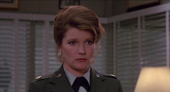 Movie still from “Remo Williams: The Adventure Begins” (1985), directed by Guy Hamilton – A person wearing a uniform; Close Up shot, Over the shoulder angle