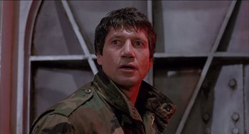 Movie still from “Remo Williams: The Adventure Begins” (1985), directed by Guy Hamilton – A person wearing a jacket; Close Up shot, Low angle