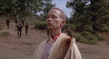 Movie still from “Remo Williams: The Adventure Begins” (1985), directed by Guy Hamilton – An old man with a beard is holding a fur coat; Close Up shot, Low angle