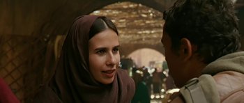 Movie still from “Rendition” (2007), directed by Gavin Hood – A woman in a head scarf talking to a man in a crowd; Close Up shot, Over the shoulder angle