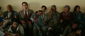 Movie still from “Rendition” (2007), directed by Gavin Hood – A group of people that are sitting on a couch; Medium shot, High angle