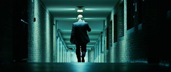 Movie still from “Rendition” (2007), directed by Gavin Hood – A man in a suit walking down a hall way; Wide shot, Low angle