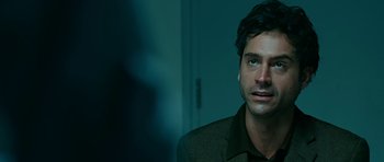 Movie still from “Rendition” (2007), directed by Gavin Hood – A person wearing a suit; Close Up shot, Over the shoulder angle