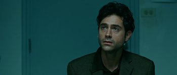 Movie still from “Rendition” (2007), directed by Gavin Hood – A person wearing a jacket; Close Up shot, Over the shoulder angle