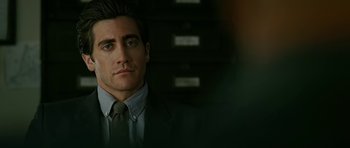 Movie still from “Rendition” (2007), directed by Gavin Hood – A person wearing a suit and tie; Close Up shot, Over the shoulder angle