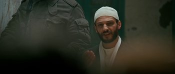 Movie still from “Rendition” (2007), directed by Gavin Hood – A man in a white hat and a white jacket; Close Up shot, Low angle