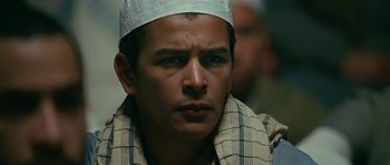 Movie still from “Rendition” (2007), directed by Gavin Hood – A person wearing a hat; Close Up shot, High angle