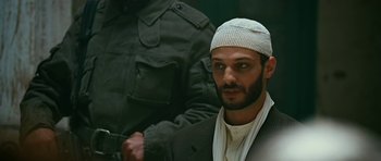 Movie still from “Rendition” (2007), directed by Gavin Hood – A person wearing a hat; Close Up shot, Low angle