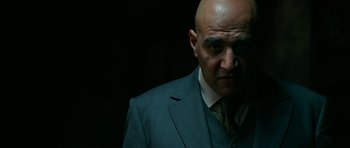 Movie still from “Rendition” (2007), directed by Gavin Hood – A man in a suit and tie looking at the camera; Close Up shot, Low angle