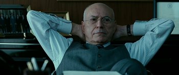 Movie still from “Rendition” (2007), directed by Gavin Hood – An older man sitting in a chair with his hands behind his head; Close Up shot, Low angle