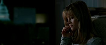Movie still from “Rendition” (2007), directed by Gavin Hood – A woman is talking on a cell phone in a dark room; Close Up shot, High angle