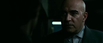 Movie still from “Rendition” (2007), directed by Gavin Hood – A person wearing a suit and tie; Close Up shot, Over the shoulder angle