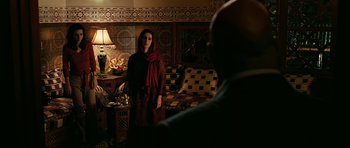 Movie still from “Rendition” (2007), directed by Gavin Hood – A woman standing in front of a man in front of a bed; Medium shot, Over the shoulder angle