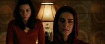 Movie still from “Rendition” (2007), directed by Gavin Hood – A woman in a red hooded jacket looking at the camera; Close Up shot, Low angle
