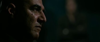 Movie still from “Rendition” (2007), directed by Gavin Hood – A man's face in the dark; Close Up shot, Over the shoulder angle
