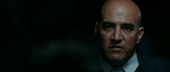 Movie still from “Rendition” (2007), directed by Gavin Hood – A man with a bald head is looking at the camera; Close Up shot, Low angle