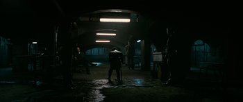 Movie still from “Rendition” (2007), directed by Gavin Hood – A group of people standing in a dark room; Wide shot, High angle