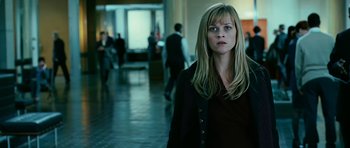 Movie still from “Rendition” (2007), directed by Gavin Hood – A woman standing in front of a group of people; Medium shot, Over the shoulder angle