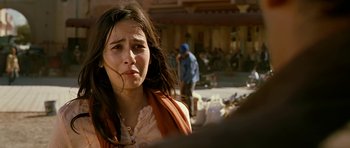 Movie still from “Rendition” (2007), directed by Gavin Hood – A young woman is standing in front of a group of people; Close Up shot, Over the shoulder angle