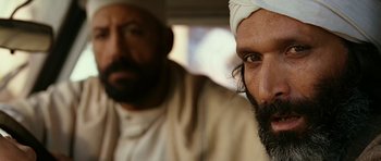 Movie still from “Rendition” (2007), directed by Gavin Hood – A man with a beard and a white turban on; Close Up shot, Over the shoulder angle