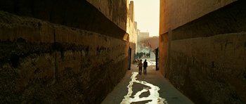 Movie still from “Rendition” (2007), directed by Gavin Hood – A group of people walking down a narrow street; Extreme Wide shot, High angle
