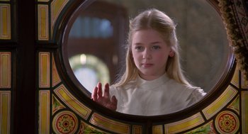 Movie still from “Return to Oz” (1985), directed by Walter Murch – A young girl looking into a mirror in a room; Close Up shot, Over the shoulder angle