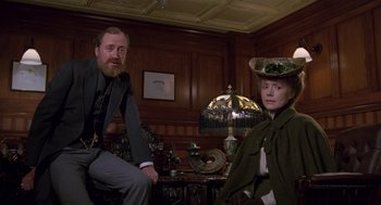 Movie still from “Return to Oz” (1985), directed by Walter Murch – A man and a woman sitting next to each other in a room; Medium shot, Low angle