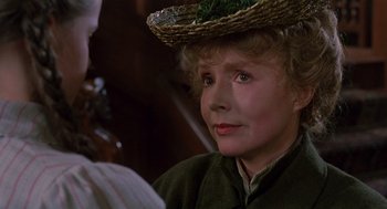 Movie still from “Return to Oz” (1985), directed by Walter Murch – An older woman wearing a straw hat and looking at the camera; Close Up shot, Over the shoulder angle