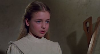 Movie still from “Return to Oz” (1985), directed by Walter Murch – A young girl in a white shirt is looking at the camera; Close Up shot, Over the shoulder angle