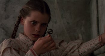 Movie still from “Return to Oz” (1985), directed by Walter Murch – A young girl holding an object in front of a mirror; Close Up shot, High angle