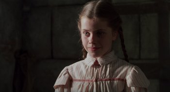 Movie still from “Return to Oz” (1985), directed by Walter Murch – A young girl in a striped dress is looking at the camera; Close Up shot, Low angle