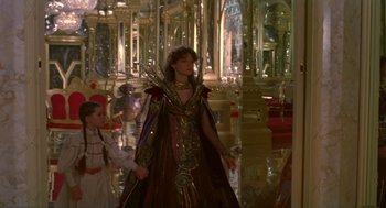 Movie still from “Return to Oz” (1985), directed by Walter Murch – A woman dressed in a costume in front of a mirror; Wide shot, Over the shoulder angle