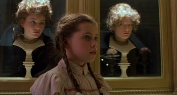 Movie still from “Return to Oz” (1985), directed by Walter Murch – A young girl with braids looking in a mirror; Close Up shot, Over the shoulder angle
