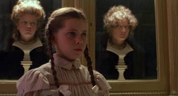Movie still from “Return to Oz” (1985), directed by Walter Murch – A young girl with braids standing in front of a mirror; Close Up shot, Over the shoulder angle