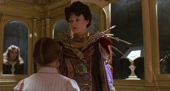 Movie still from “Return to Oz” (1985), directed by Walter Murch – A woman dressed in a costume looking in a mirror; Medium shot, Over the shoulder angle