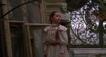 Movie still from “Return to Oz” (1985), directed by Walter Murch – A young girl in a dress stands in front of a bust; Medium shot, Low angle