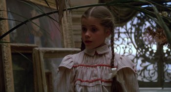 Movie still from “Return to Oz” (1985), directed by Walter Murch – A young girl with long hair in a striped dress; Close Up shot, Low angle
