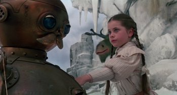Movie still from “Return to Oz” (1985), directed by Walter Murch – A young girl holding onto the arm of an alien creature; Close Up shot, Over the shoulder angle