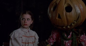 Movie still from “Return to Oz” (1985), directed by Walter Murch – A girl and a person in a pumpkin costume; Close Up shot, Over the shoulder angle