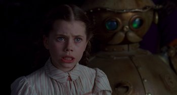 Movie still from “Return to Oz” (1985), directed by Walter Murch – A young girl standing in front of a large robot; Close Up shot, Over the shoulder angle
